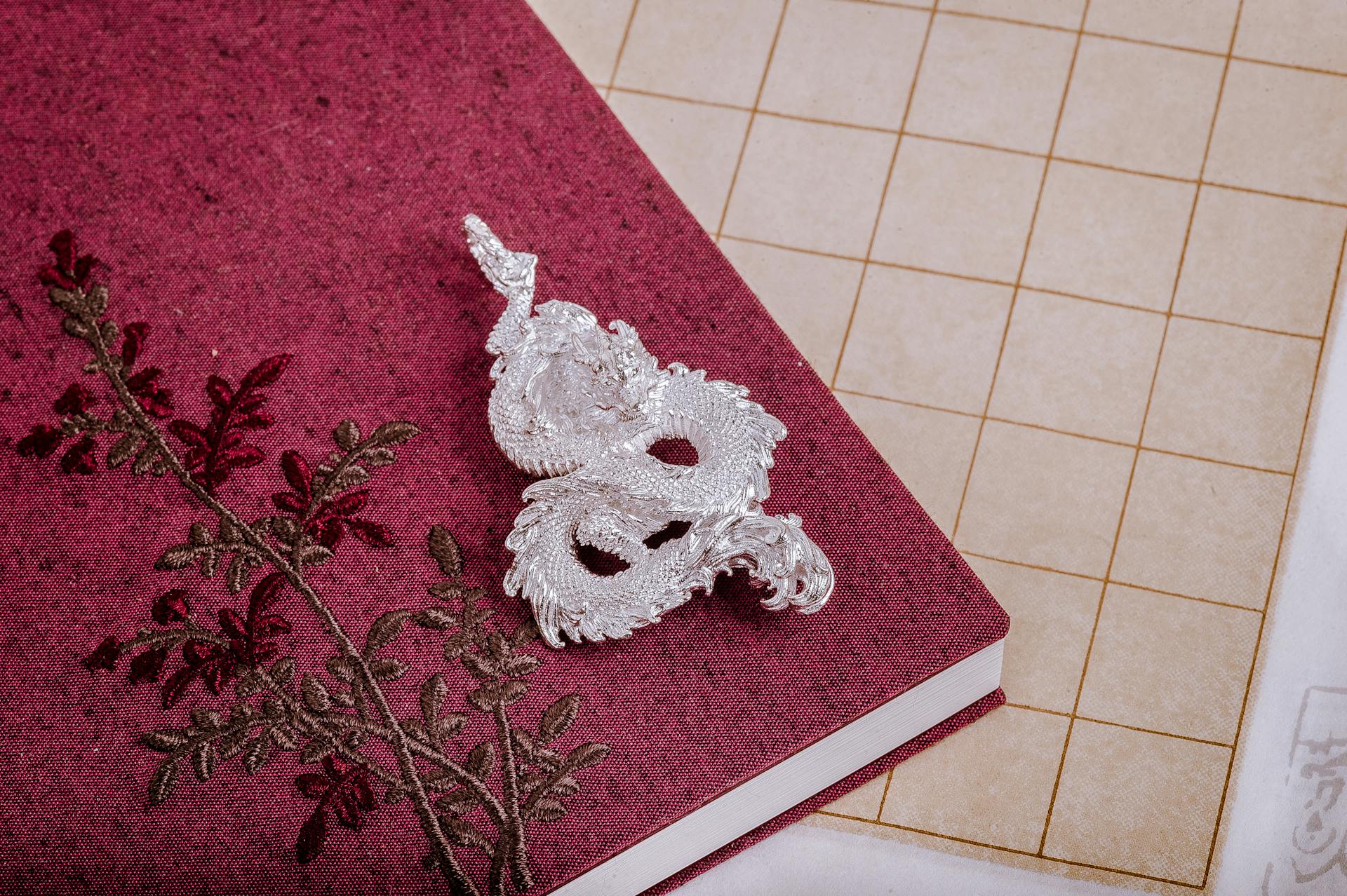 Silver Vintage Dragon on a Notebook