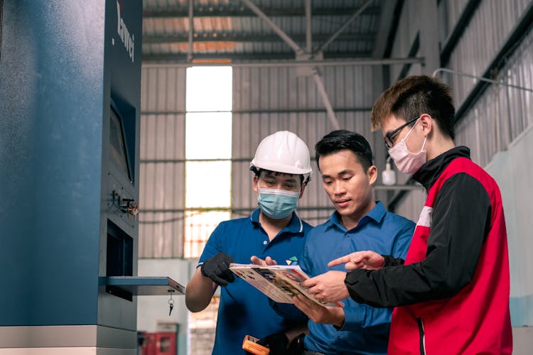 Men In Masks And Helmet In Warehouse