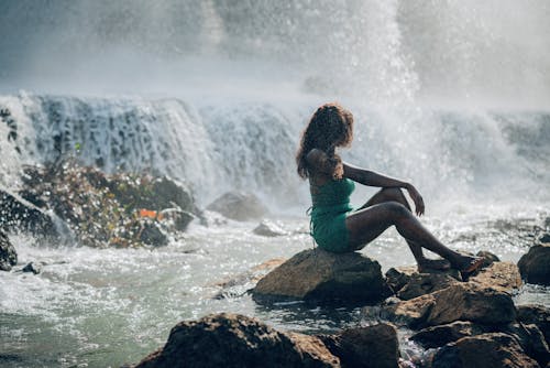 Woman Relaxing by Waterfall