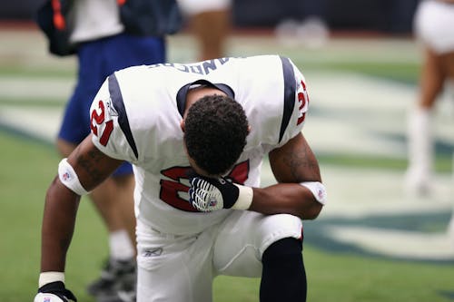Free Football Player on Bended Knees Stock Photo