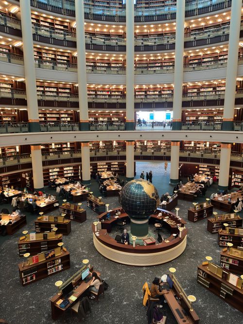 Free A breathtaking view of a library in Turkey featuring a central globe and multilevel bookshelves. Stock Photo
