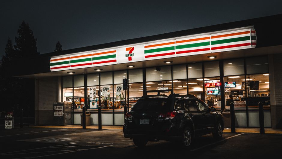 7-Eleven exterior with emergency lights flashing