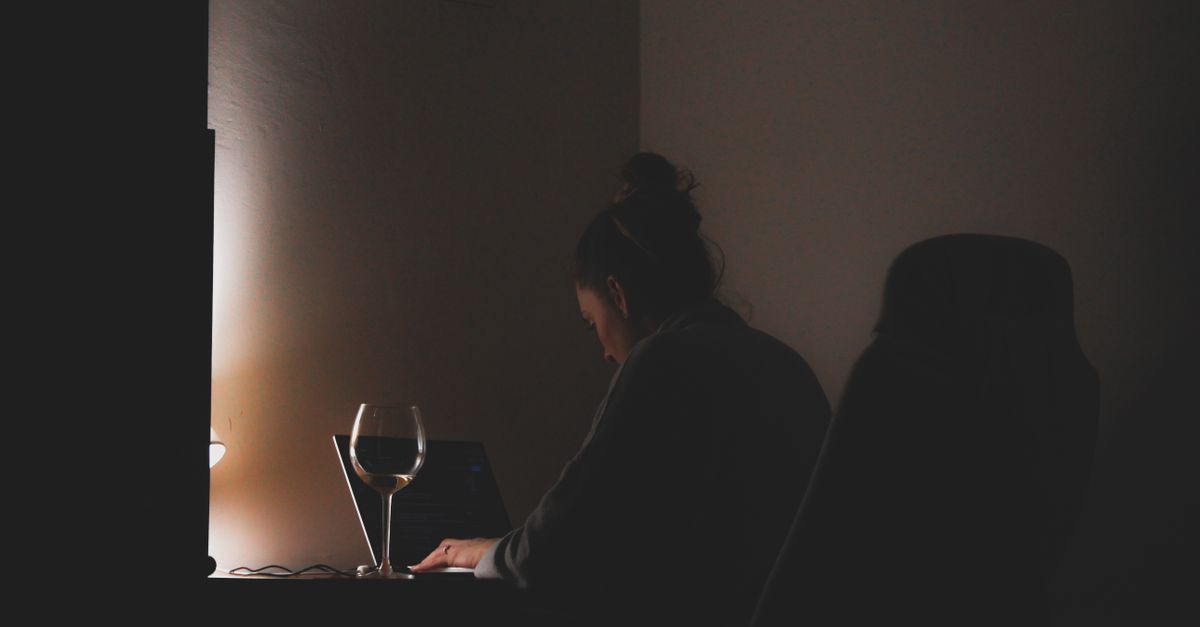 person working late night laptop home office