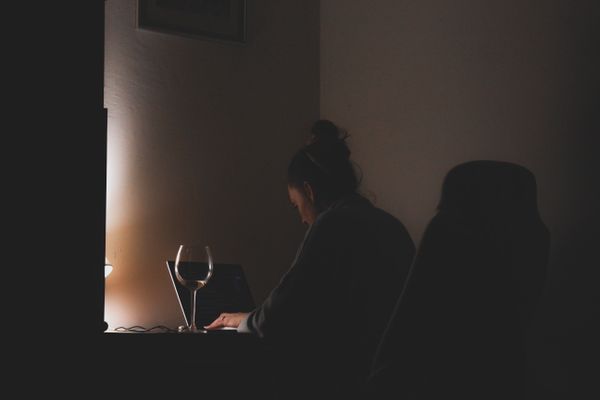 Person working at a laptop in a dim room — photo by Czapp Árpád on Pexels