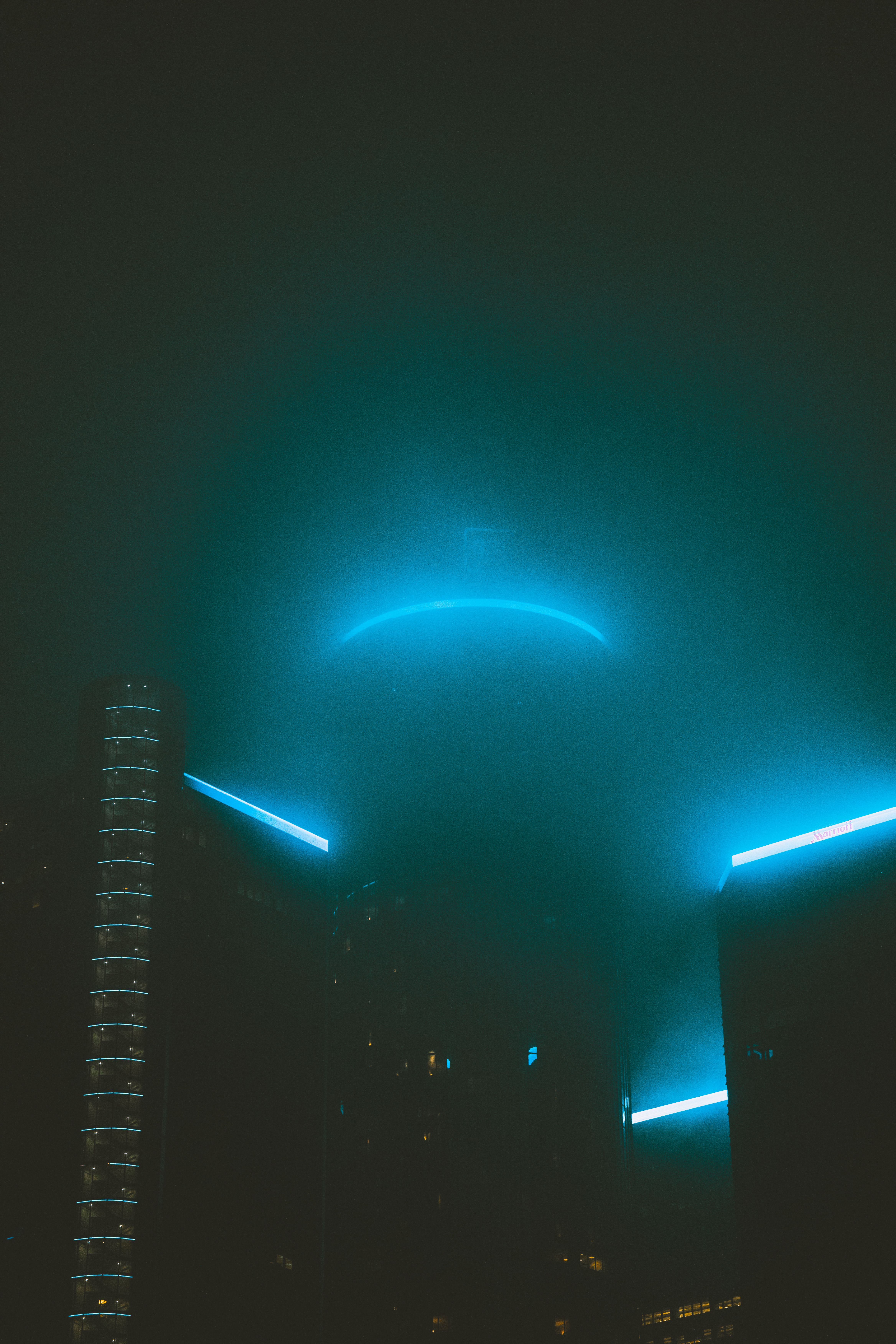 futuristic cityscape with glowing blue lights at night