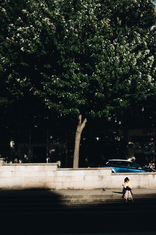 Person Sitting On Pavement