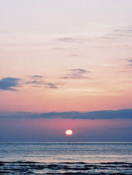 A tranquil sunset over the Baltic Sea with a pink sky in Klaipėda, Lithuania.