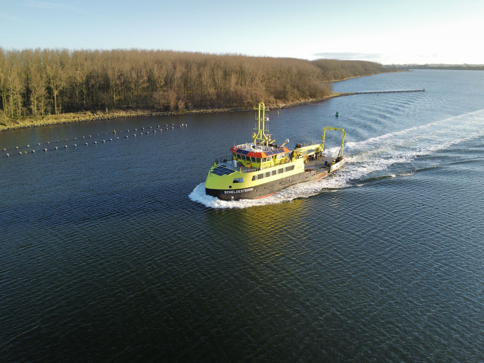 Aerial view of a research vessel on a calm river