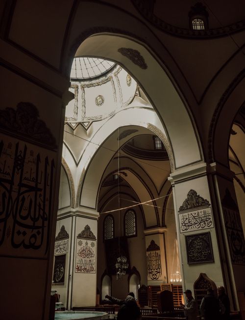 Free A detailed view of the Grand Mosque's arches and dome in Bursa, featuring Islamic calligraphy. Stock Photo