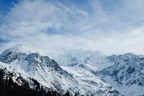 Free A breathtaking view of snow-covered mountain peaks under a clear blue sky. Stock Photo