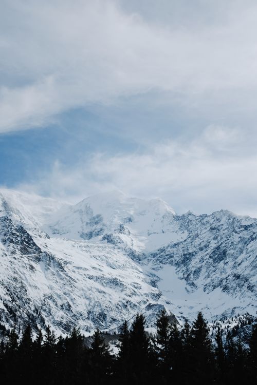 Free Stunning view of a snowcapped mountain range with a clear blue sky, capturing the beauty of winter nature. Stock Photo
