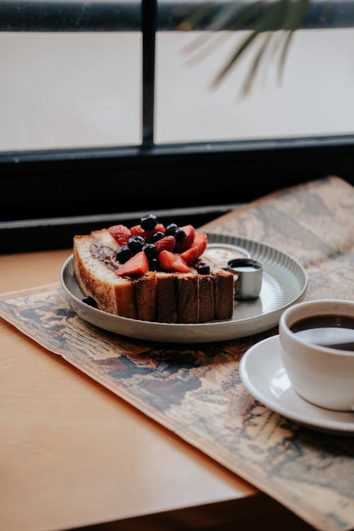 Free A Cup of Coffee and a Slice of Cake on the Table  Stock Photo
