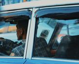 Back view of a man driving a vintage car in Addis Ababa, Ethiopia.