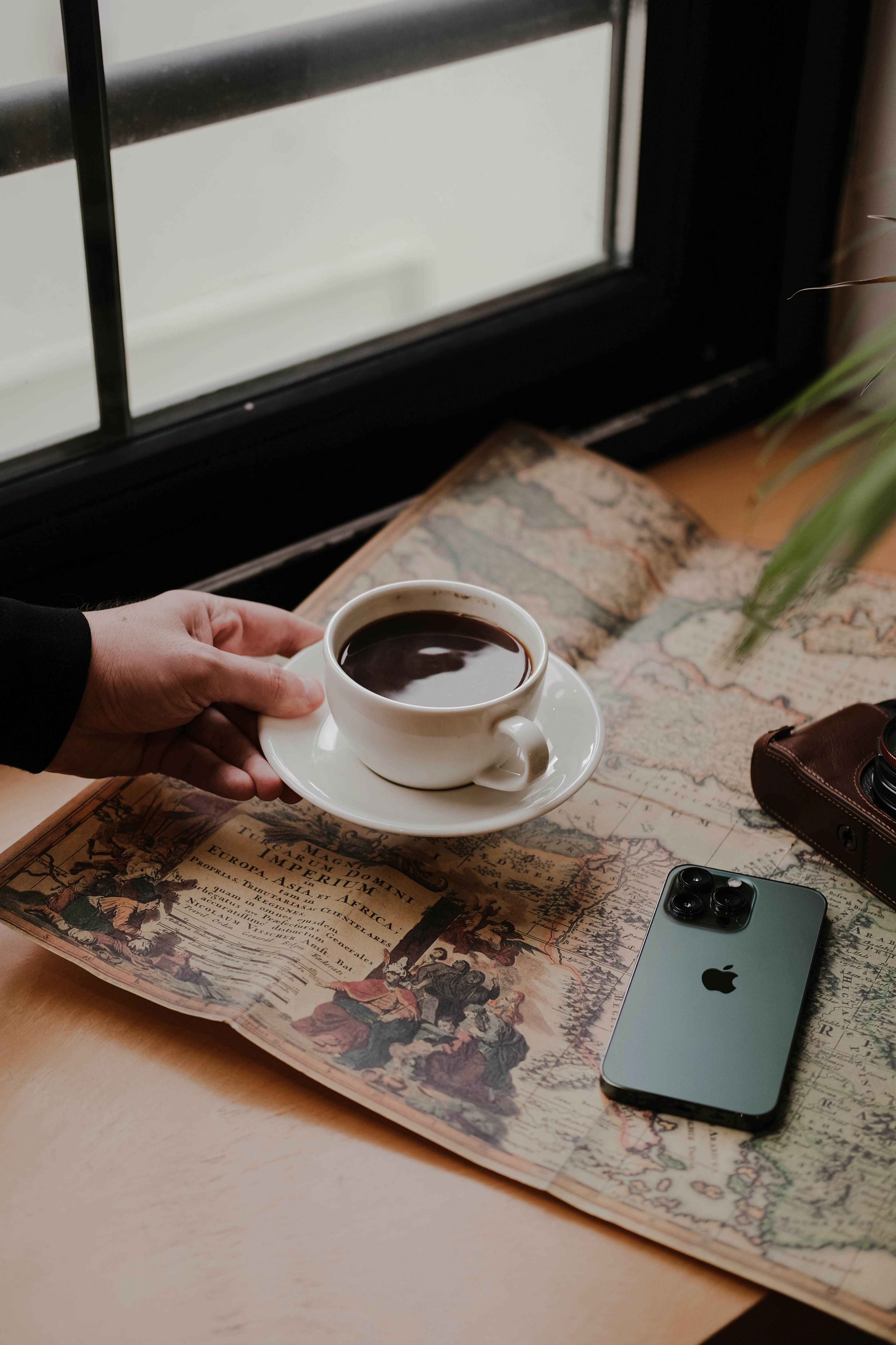 hand putting off coffee on a table