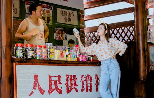 Woman Buying a Can of Soda at the Street Food Stall