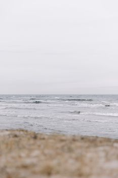 Peaceful view of waves on an overcast day at the coast, ideal for a calm nature theme.