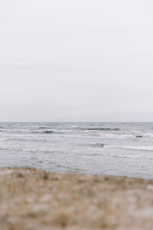 Free Peaceful view of waves on an overcast day at the coast, ideal for a calm nature theme. Stock Photo