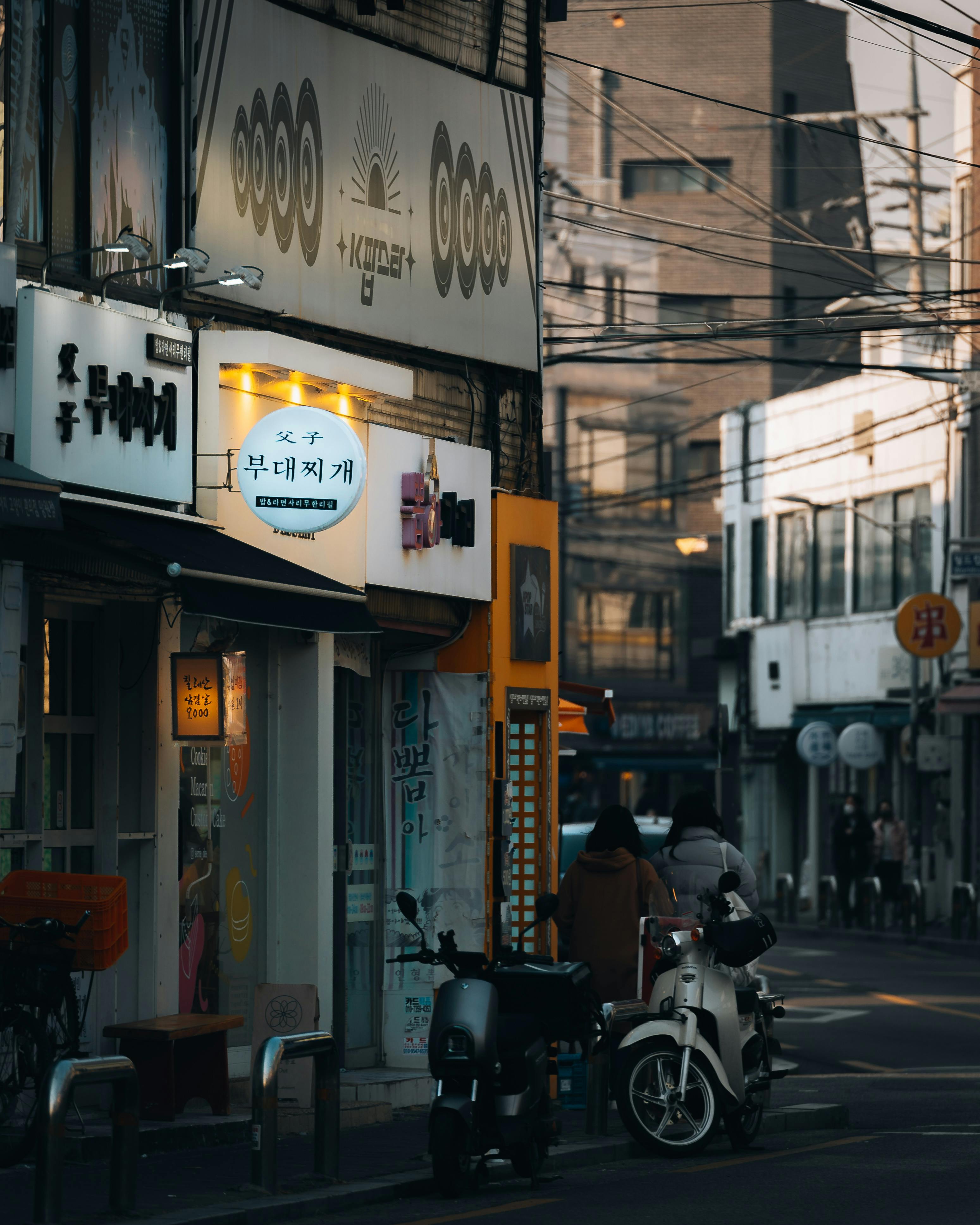 view of pedestrians walking on a sidewalk by the buildings in city