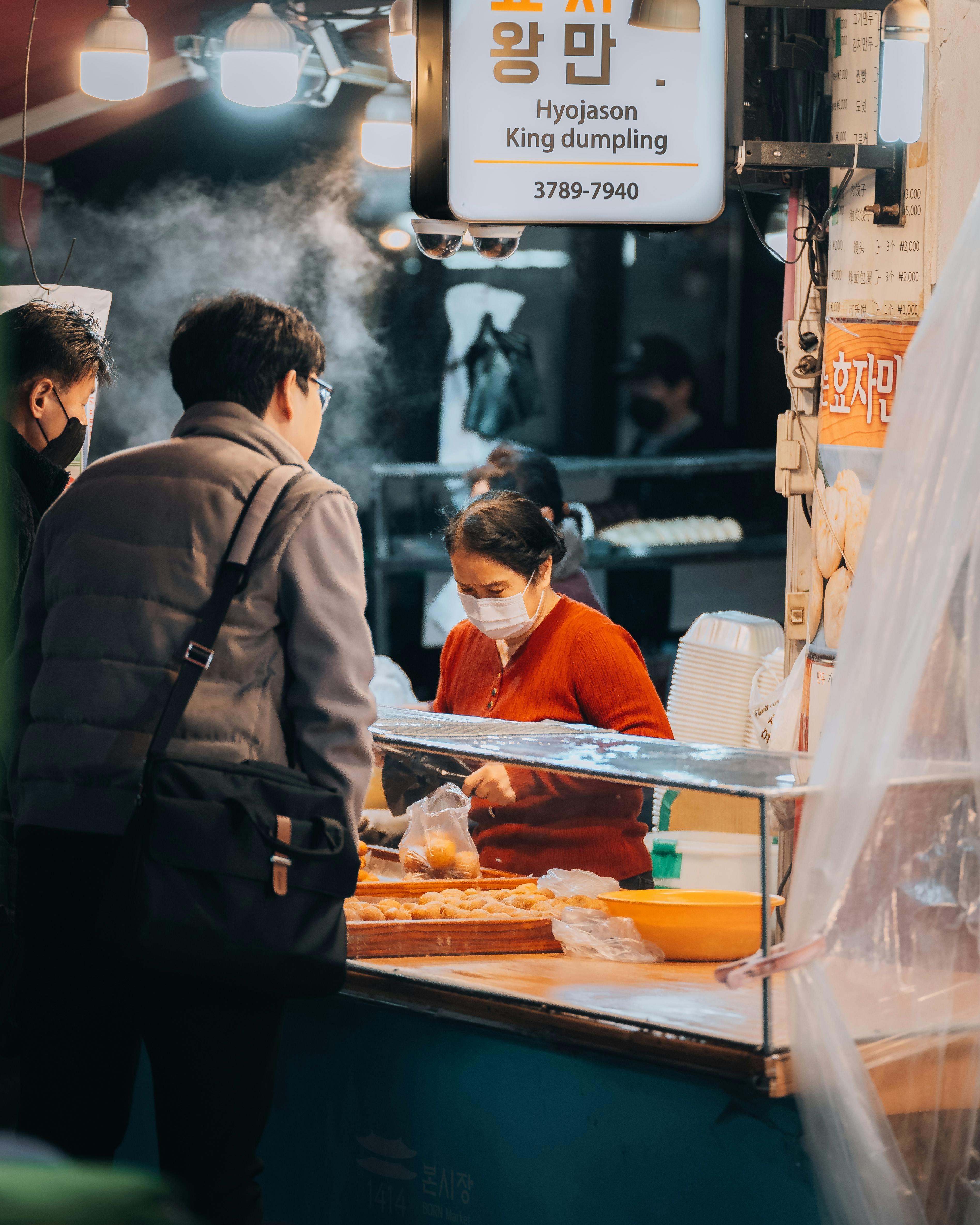 people buying food at a street food market