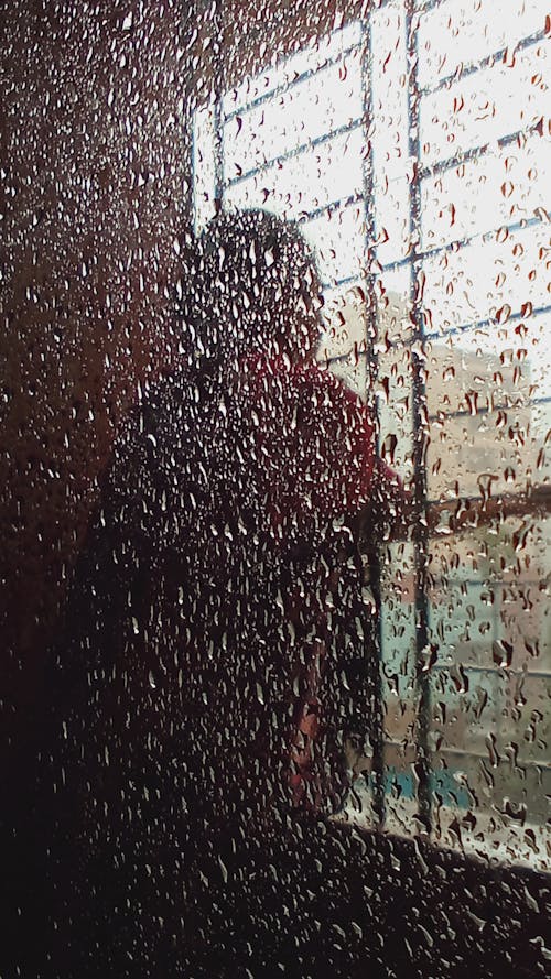 Aesthetic raindrops on glass while raining cats and dogs