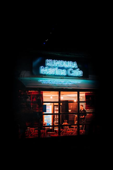 Neon-lit cafe in Istanbul with glowing sign at night, showcasing urban charm.