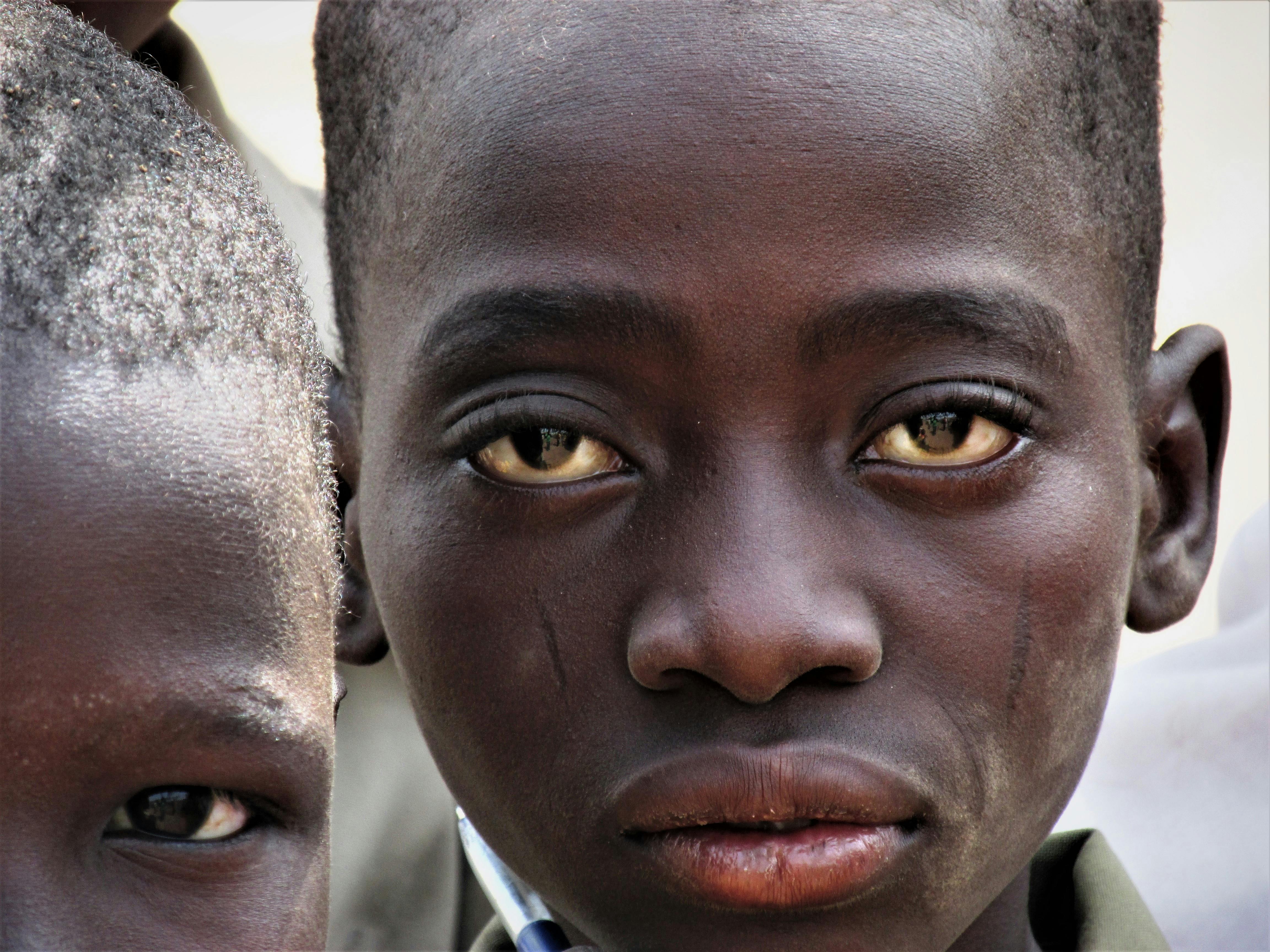 Captivating close-up portrait of a child in Fada-Ngourma, Burkina Faso, revealing deep expressions.