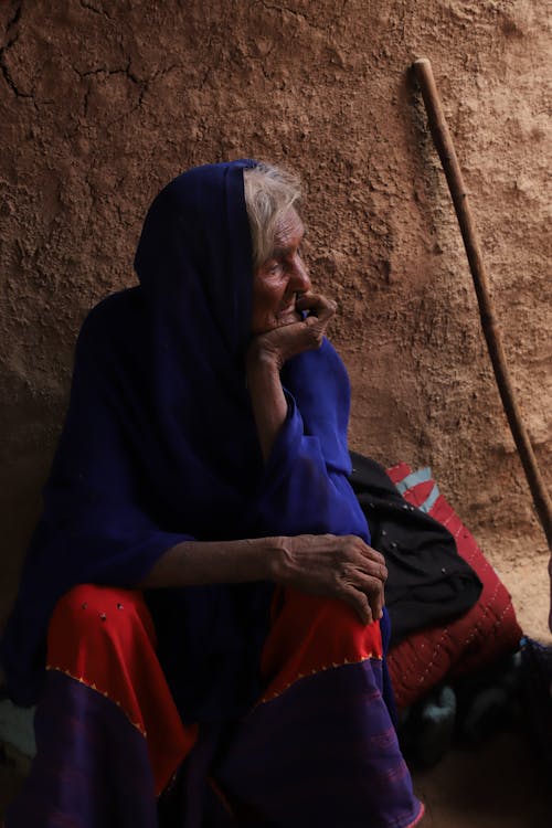 Woman Sitting in Traditional Clothing