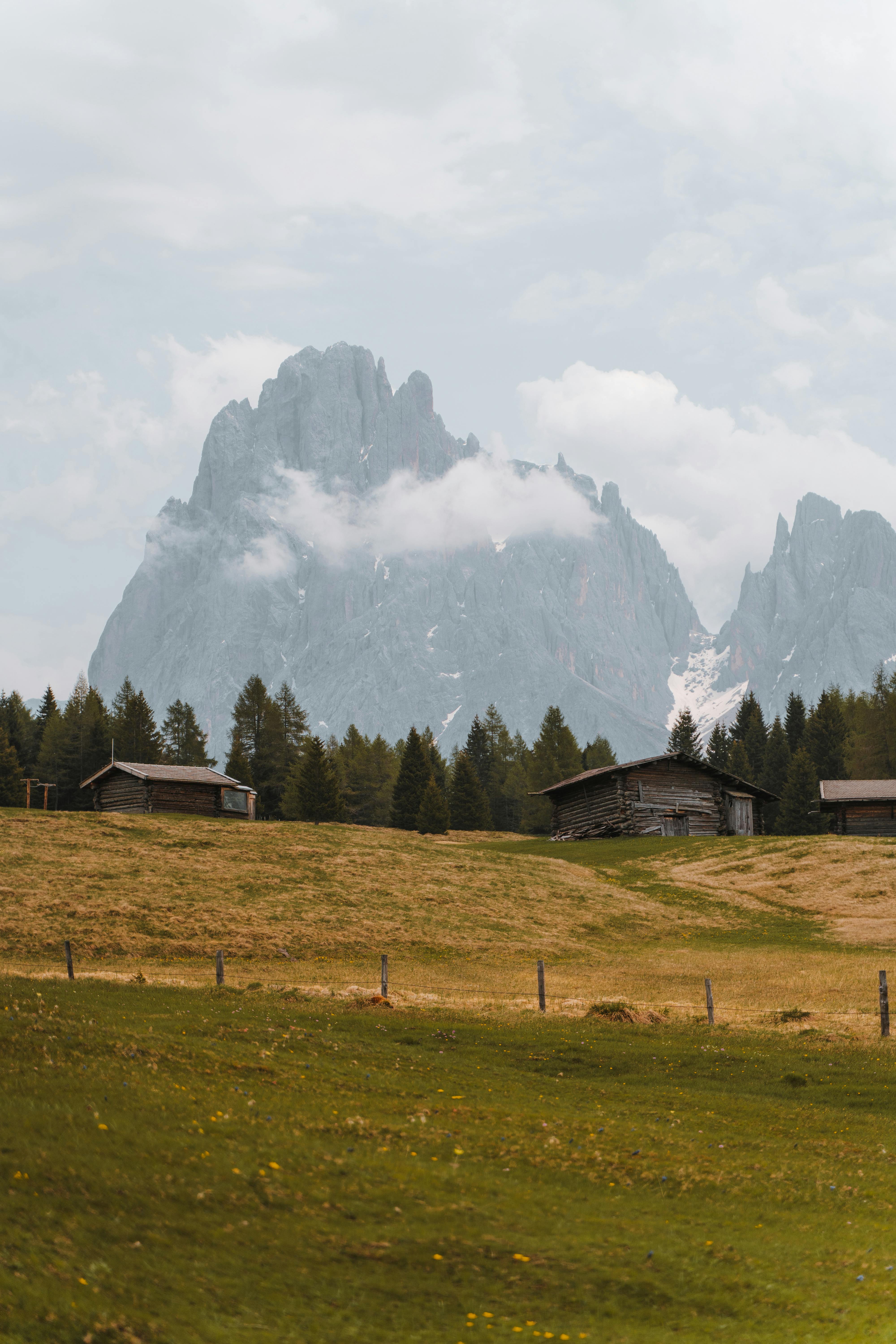 A picturesque view of Sankt Ulrich, Italy, featuring alpine meadows and mountains in autumn.