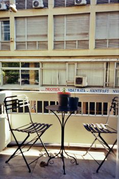 Modern balcony in Athens overlooking urban buildings. Ideal for cityscape lovers.