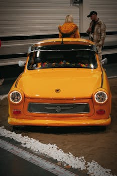 Explore the classic Trabant 601 showcased at a car exhibition in Hungary, featuring retro design and vibrant colors.