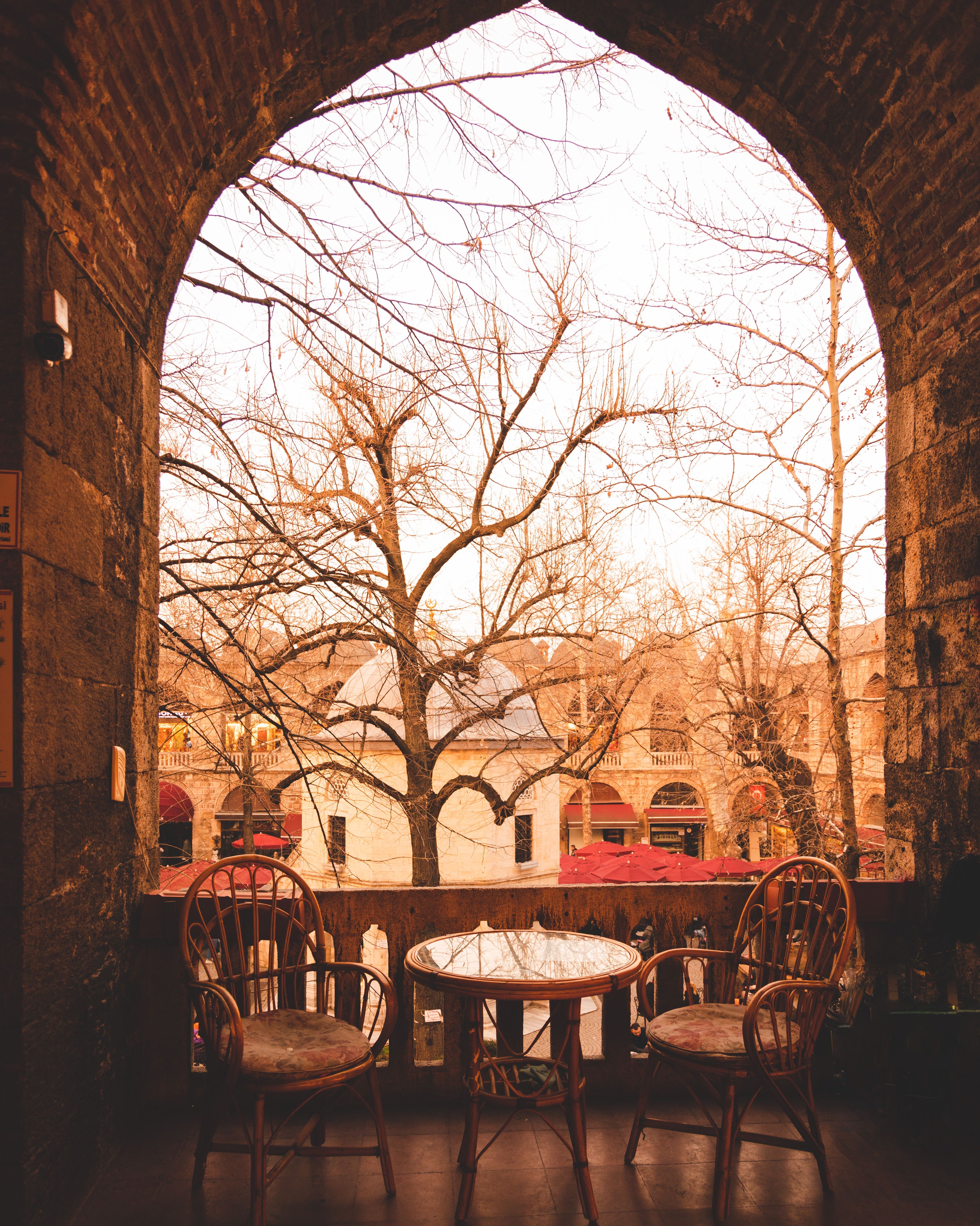 Picturesque terrace view with rustic chairs and table in historical Bursa, Türkiye.