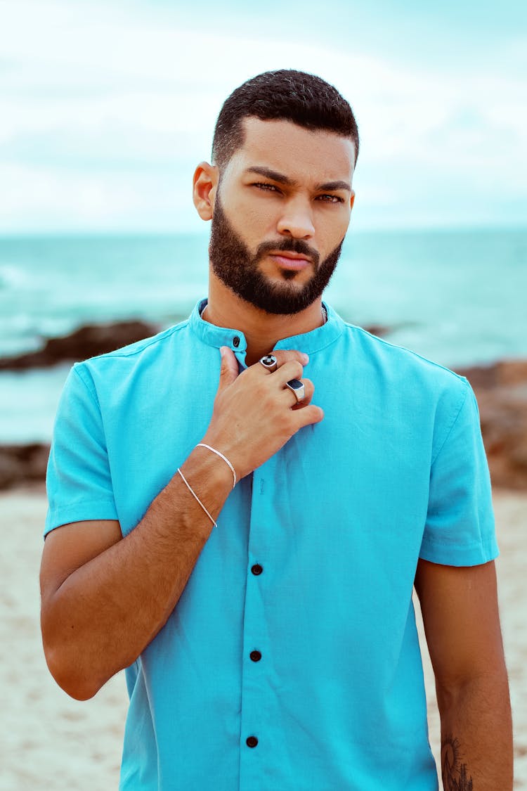 Man In A Blue Shirt On A Beach 