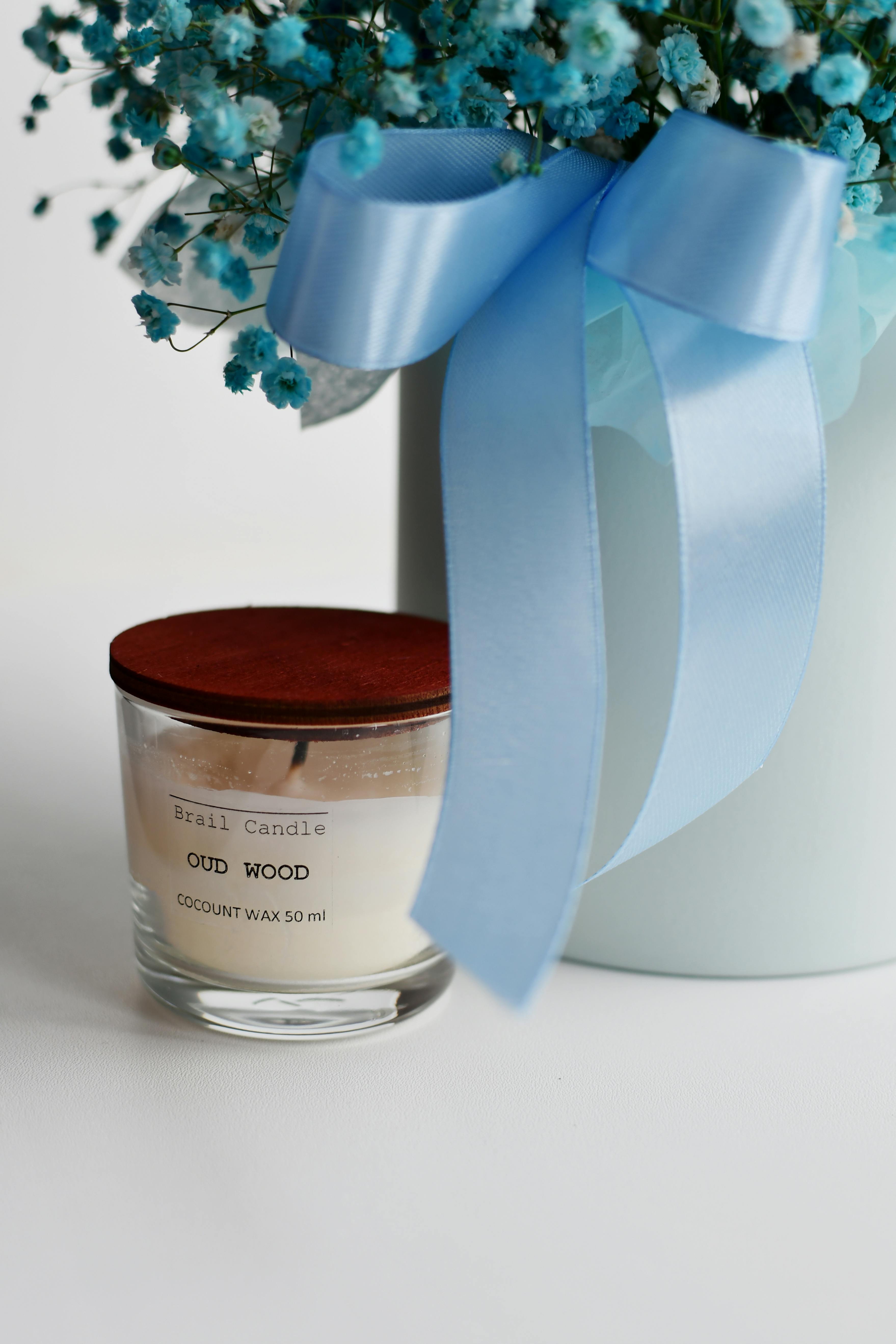 Oud Wood Candle and Flowers in Vase · Free Stock Photo