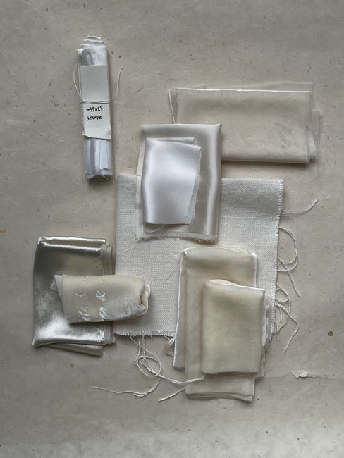 A collection of elegant fabric samples neatly arranged on a neutral background for design inspiration.