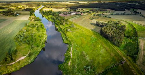 Free A stunning aerial view of the lush green countryside and river in Rogusko, Poland. Stock Photo
