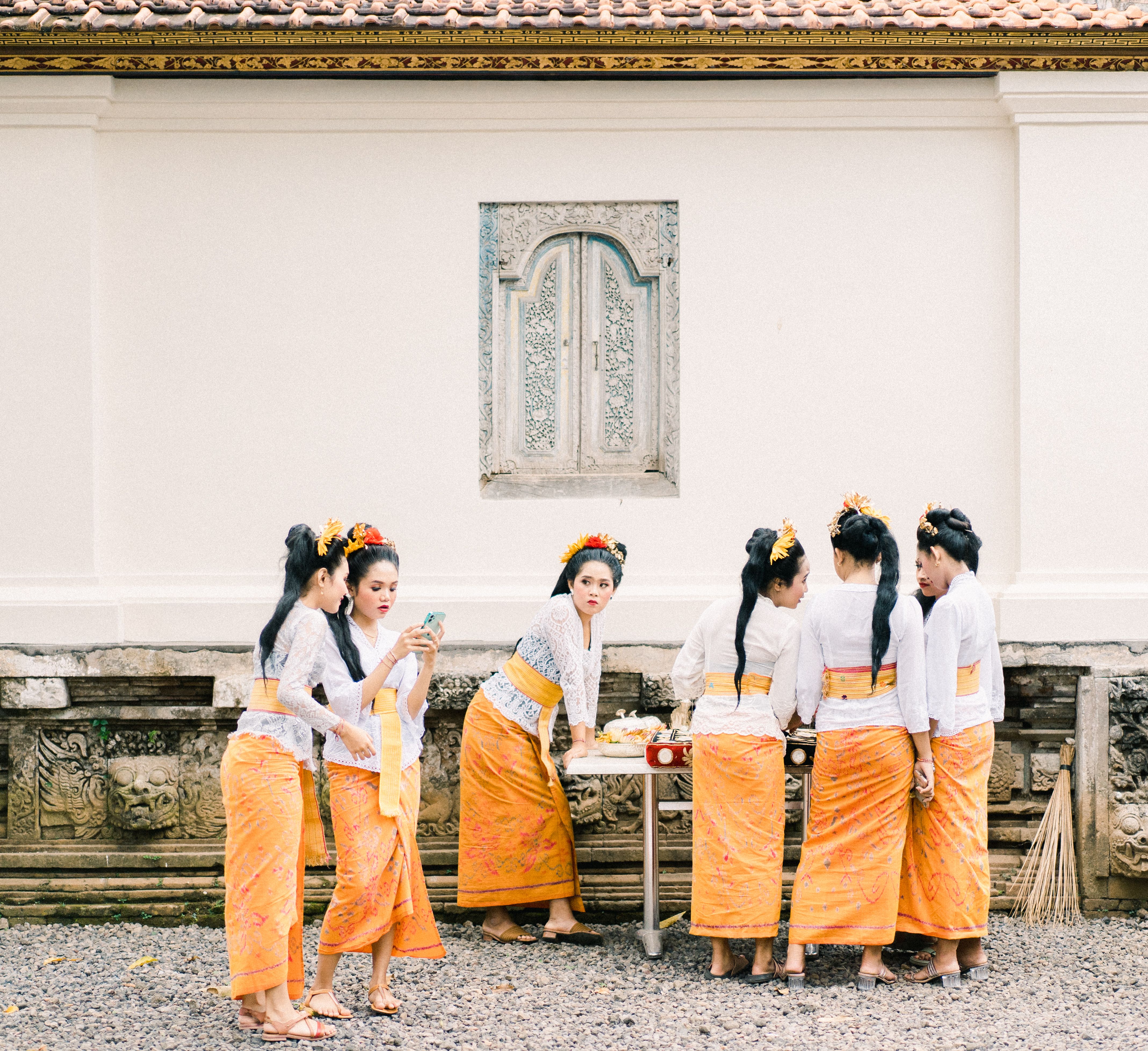Balinese women gather in traditional dress, embodying cultural richness and community spirit.