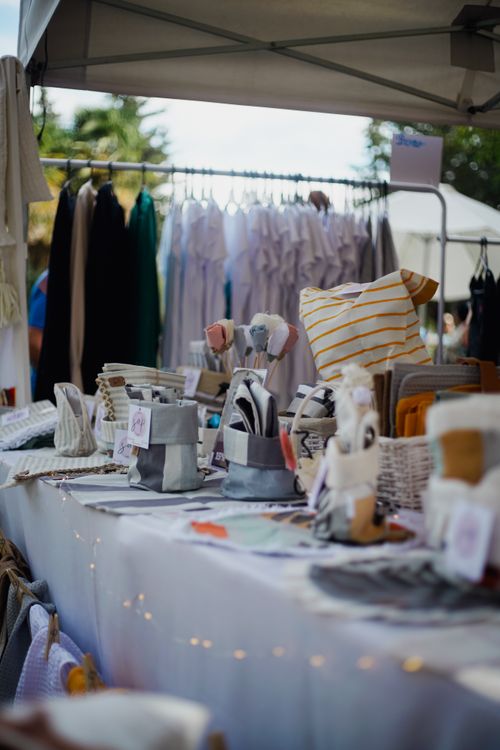 Free Colorful display of handmade items at an outdoor market stall showcasing artisanal craftsmanship. Stock Photo