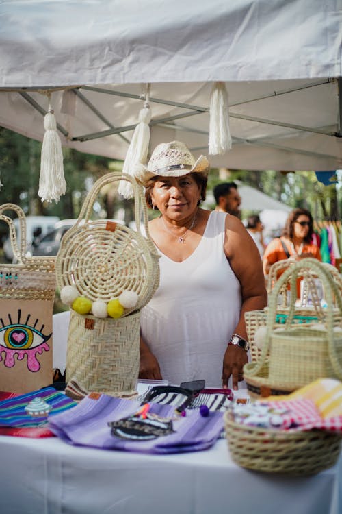 An Elderly Woman Selling Handmade Stuff at the Market