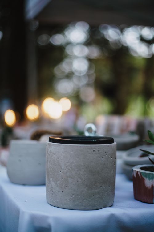 Free Close-up of a handmade ceramic pot on a table at an outdoor market. Evening lights create a cozy atmosphere. Stock Photo
