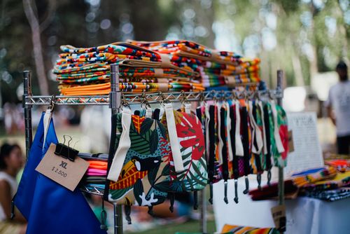 Free Vibrant handmade bags and textiles displayed at an outdoor market. Stock Photo