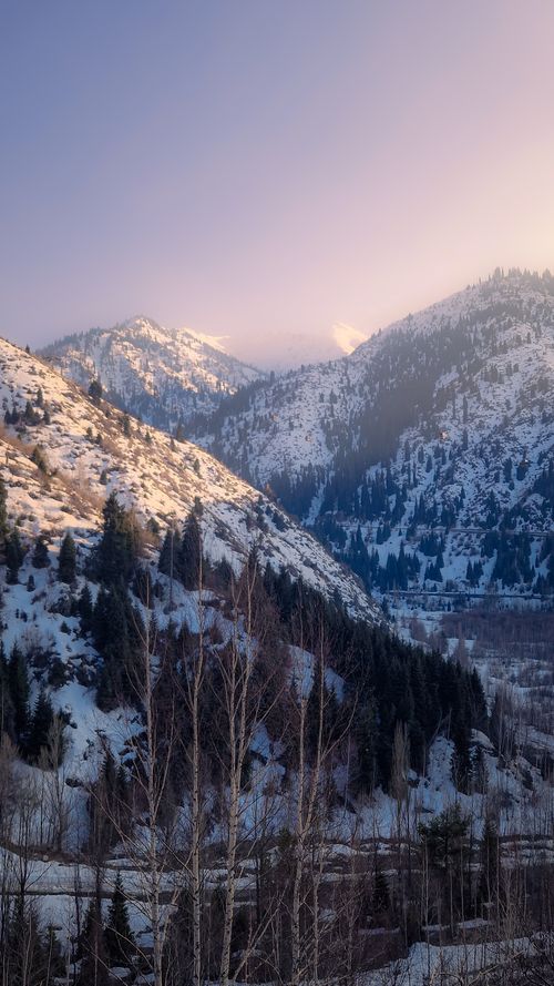 Free Scenic winter view of the snow-covered mountains in Almaty, Kazakhstan during sunset. Stock Photo