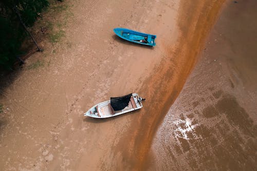 Two Blue and White Boats On Shore