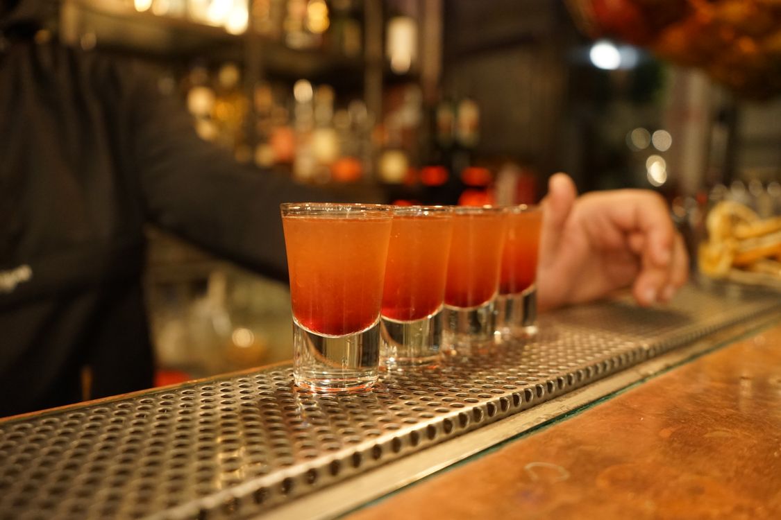 Cocktail Dropbacks Close-up of Vodka Shots Standing on the Bar Counter · Free Stock Photo