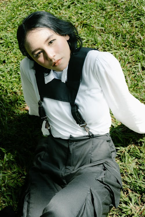 Woman Sitting on Grass and Posing