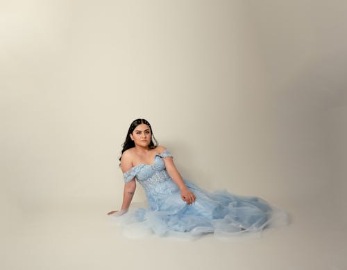 Woman in Blue Dress Sitting and Posing