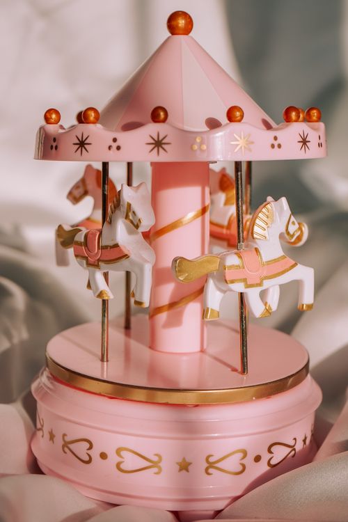 Free Elegant pink carousel music box with decorative horses, perfect for gifts. Stock Photo