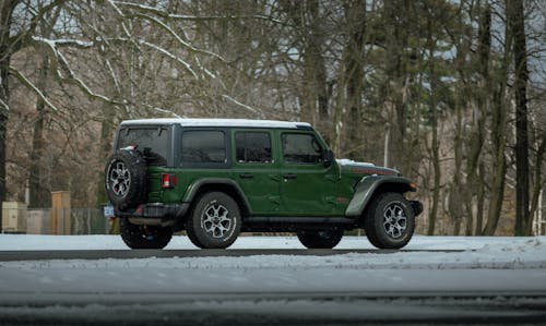 Green Jeep Wrangler Parked by the Park