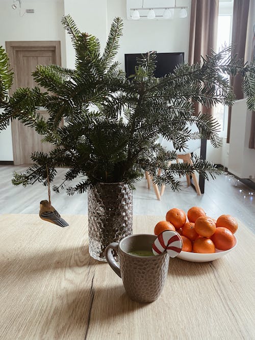 Winter mood, cup of hot drink with gingerbread and tangerines