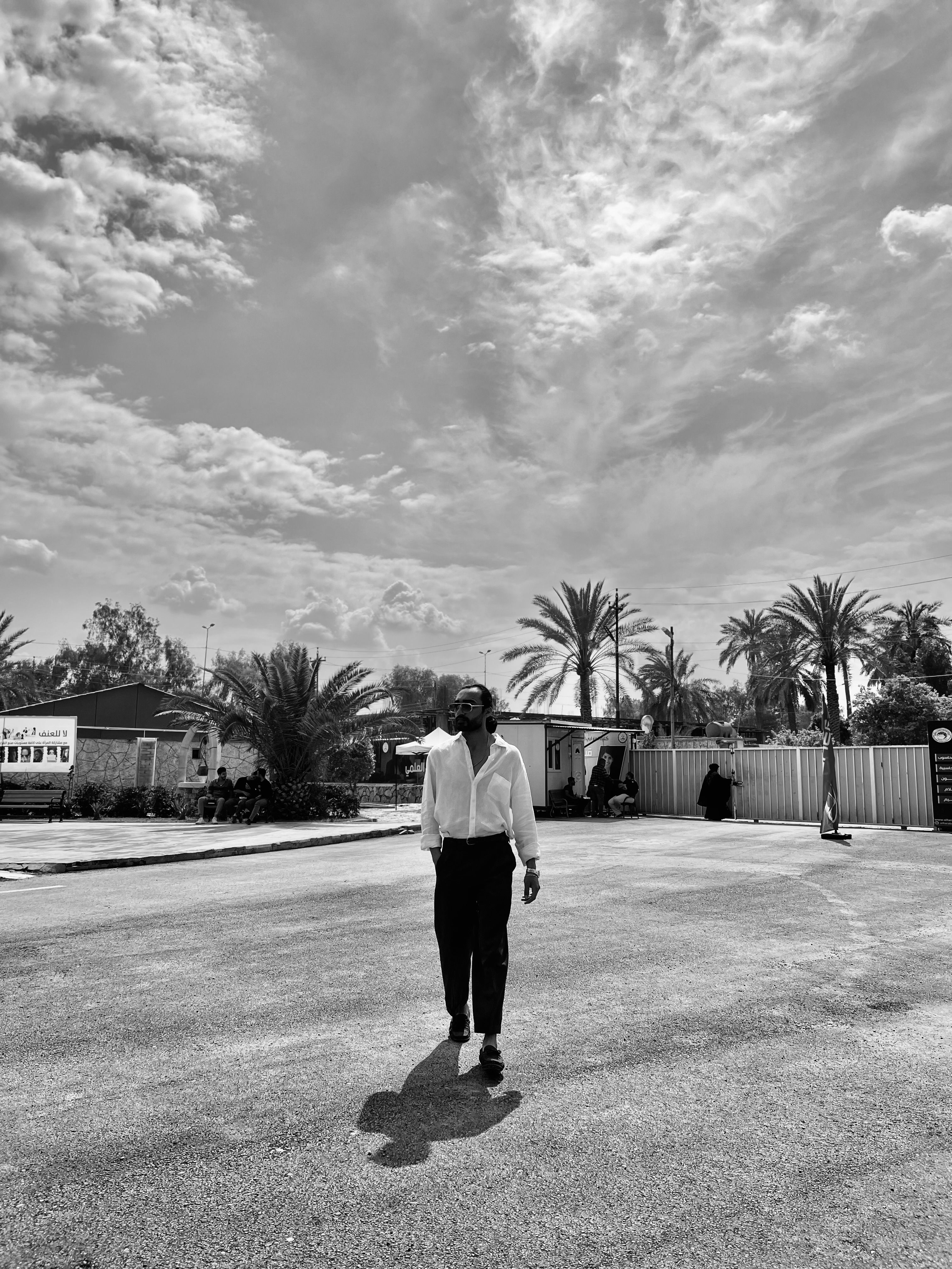 An Adult Man Walking on a Street in Black and White · Free Stock Photo