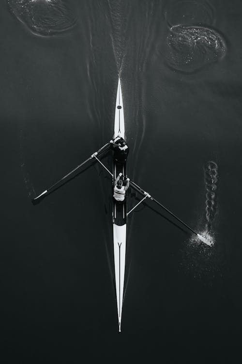 A Man Kayaking in Black and White
